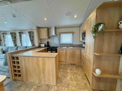 a kitchen with wooden cabinets and a kitchen island at Glenmoor Lodge in Clitheroe