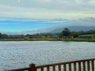 a large body of water with houses and a fence at Glenmoor Lodge in Clitheroe