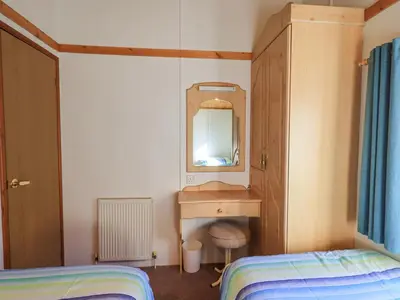 a bedroom with a sink and a mirror at Kellet Lodge Lakeside 26 in Carnforth