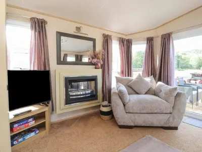 a living room with a chair and a television at Ashcroft in Preston