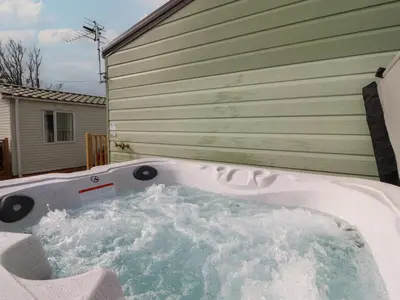 a jacuzzi tub sitting outside of a house at Ashcroft in Preston