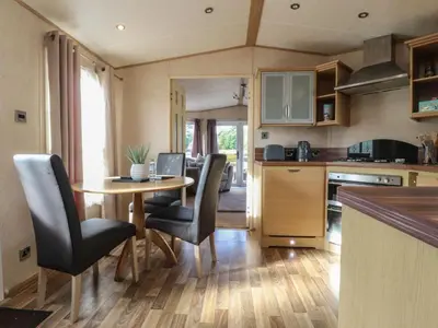 a kitchen and dining room with a table and chairs at Ashcroft in Preston