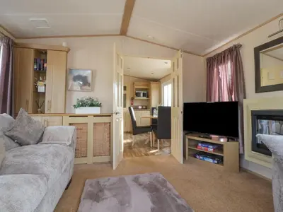 a living room with a couch and a flat screen tv at Ashcroft in Preston