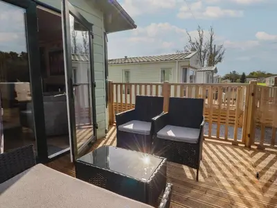 a deck with two chairs and a coffee table at Ashcroft in Preston