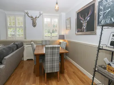 a living room with a table and a couch at 1 Boarbank Farm in Grange Over Sands