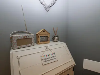 a small house on top of a dresser at 1 Boarbank Farm in Grange Over Sands