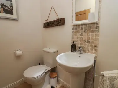 a bathroom with a toilet and a sink at 1 Boarbank Farm in Grange Over Sands