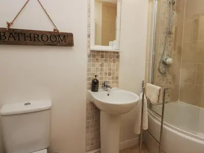 a bathroom with a sink and a toilet and a shower at 1 Boarbank Farm in Grange Over Sands