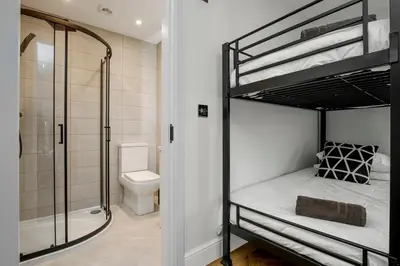 a bathroom with two bunk beds and a shower at The Boot Rooms Anfield in Liverpool