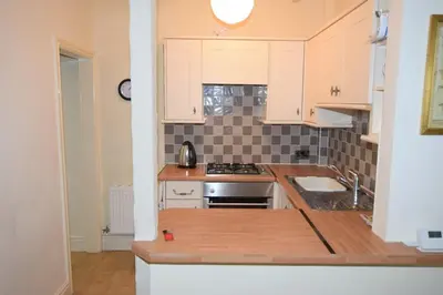 a kitchen with white cabinets and a stove top oven at Perfect House for Healthcare worker in Barrow in Furness