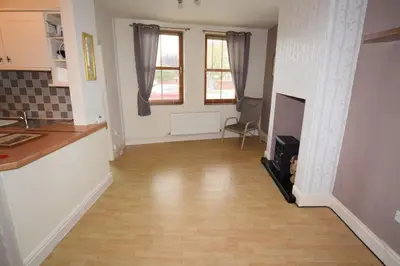 a room with a kitchen and a hard wood floor at Perfect House for Healthcare worker in Barrow in Furness