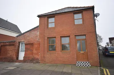 a red brick house with a door on a street at Perfect House for Healthcare worker in Barrow in Furness
