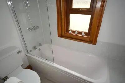 a bathroom with a tub and a toilet and a window at Perfect House for Healthcare worker in Barrow in Furness
