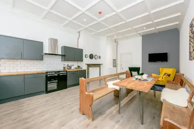 a kitchen with a table and a dining room at No 27 Liverpool in Liverpool