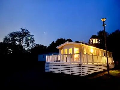 a house with a light on the side of it at Ribble Valley Lodge in Longridge