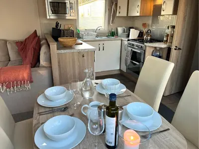 a kitchen with a table with a bottle of wine on it at Ribble Valley Lodge in Longridge