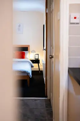 a bedroom with a bed and a nightstand with a bed sidx sidx sidx sidx at Westminster Apartment in Liverpool