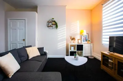 a living room with a couch and a tv at Westminster Apartment in Liverpool