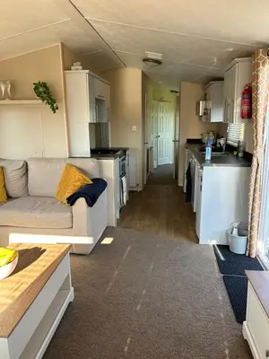 a living room with a couch and a kitchen at J&D by the sea in Heysham