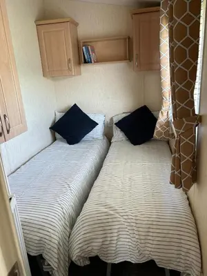 two beds sitting next to each other in a bedroom at J&D by the sea in Heysham