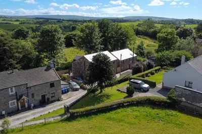 an aerial view of a small village with cars parked at Luxury 18th Century Stone Built Cottage in Lower Bentham