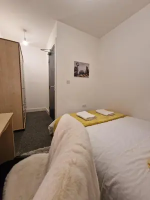 a bedroom with two beds with towels on them at Luxury house in Kensington for 21 guests in Liverpool