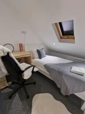 a bedroom with two beds and a desk and a chair at Luxury house in Kensington for 21 guests in Liverpool