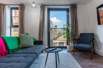 a living room with a couch and a window at Top Floor City Stay Beatles Bars & Nightlife in Liverpool