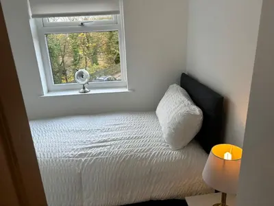 a small bedroom with a bed and a window at Williamson House Lancaster in Lancaster