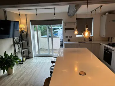 a kitchen with a table and a view of a yard at Williamson House Lancaster in Lancaster