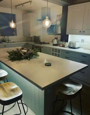 a kitchen with a large island with two stools at Williamson House Lancaster in Lancaster