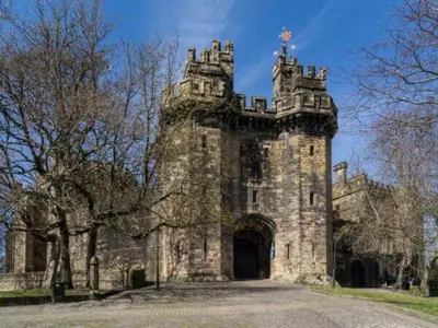 an old stone building with a gate in the middle at Williamson House Lancaster in Lancaster