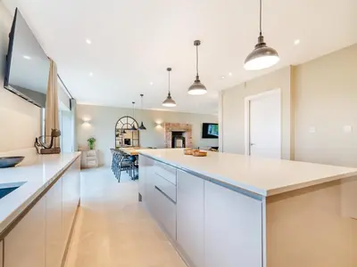 a kitchen with white cabinets and a white counter top at Cherry Tree Cottage - Uk47756 in Mellor