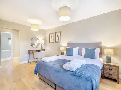 a bedroom with a large bed with two pillows at Cherry Tree Cottage - Uk47756 in Mellor