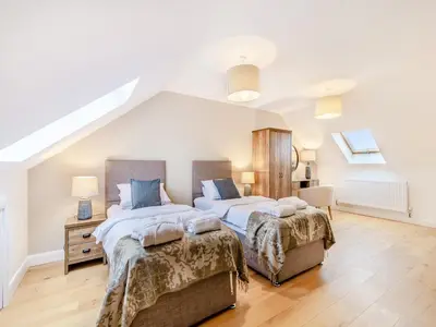two beds in a bedroom with white walls at Cherry Tree Cottage - Uk47756 in Mellor