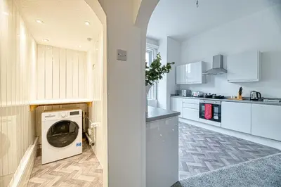 a kitchen with a washer and dryer at Glendale House by Guestz in Lytham St Annes