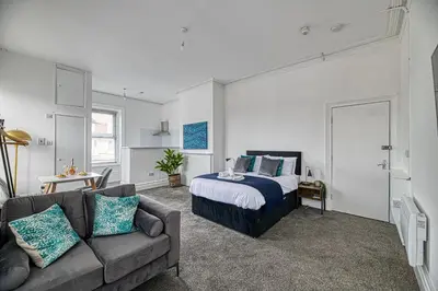 a living room with a bed and a couch at Glendale House by Guestz in Lytham St Annes