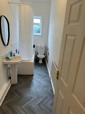 a bathroom with a toilet and a sink and a mirror at Abigail house in Westhoughton
