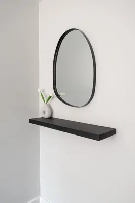 a black shelf with a mirror on a wall at Liverpool City Haven 1-Bed Apartment for Couples & Solo Travelers in Liverpool