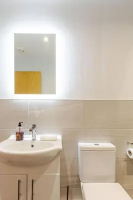 a bathroom with a white toilet and a sink at Liverpool City Haven 1-Bed Apartment for Couples & Solo Travelers in Liverpool