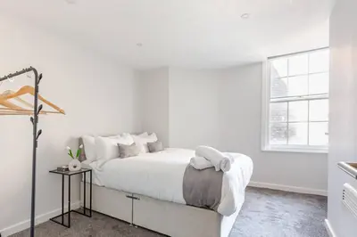 a white bedroom with a bed and a window at Modern 1-Bedroom City Centre Apartment, Liverpool Hideaway in Liverpool