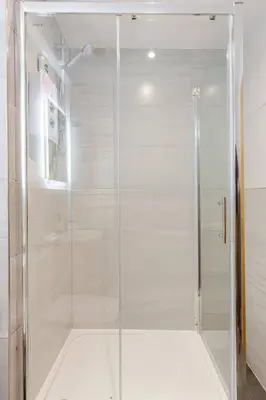 a shower with a glass door in a bathroom at Modern 1-Bedroom City Centre Apartment, Liverpool Hideaway in Liverpool