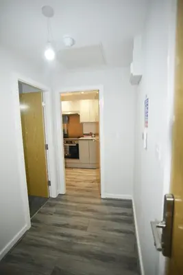 a hallway leading to a kitchen in a apartment at Modern 1-Bedroom City Centre Apartment, Liverpool Hideaway in Liverpool