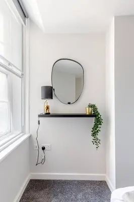 a mirror on a wall next to a window at Modern 1-Bedroom City Centre Apartment, Liverpool Hideaway in Liverpool