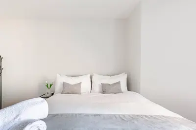 a white bedroom with a large white bed with pillows at Modern 1-Bedroom City Centre Apartment, Liverpool Hideaway in Liverpool