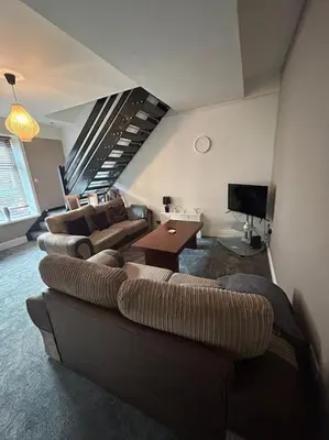 a living room with a couch and a tv at Entire House - 4 Bed - Sleeps 6 in Clayton le Moors