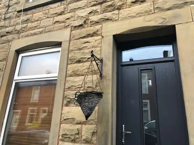 a basket hanging on the side of a building at Entire House - 4 Bed - Sleeps 6 in Clayton le Moors