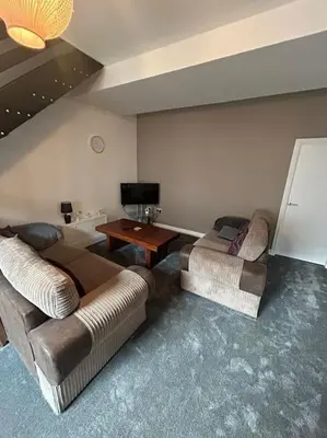 a living room with two couches and a tv at Entire House - 4 Bed - Sleeps 6 in Clayton le Moors