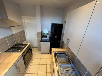 a small kitchen with a stove and a sink at Entire House - 4 Bed - Sleeps 6 in Clayton le Moors