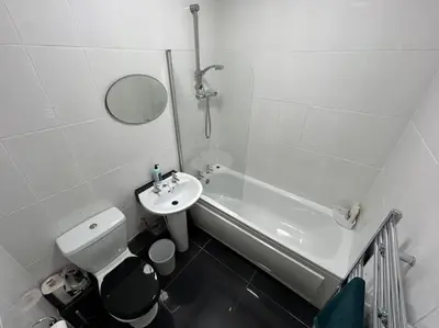 a white bathroom with a sink and a toilet at Entire House - 4 Bed - Sleeps 6 in Clayton le Moors